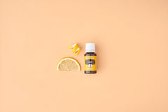 Fresh lemon slices beside lemon oil