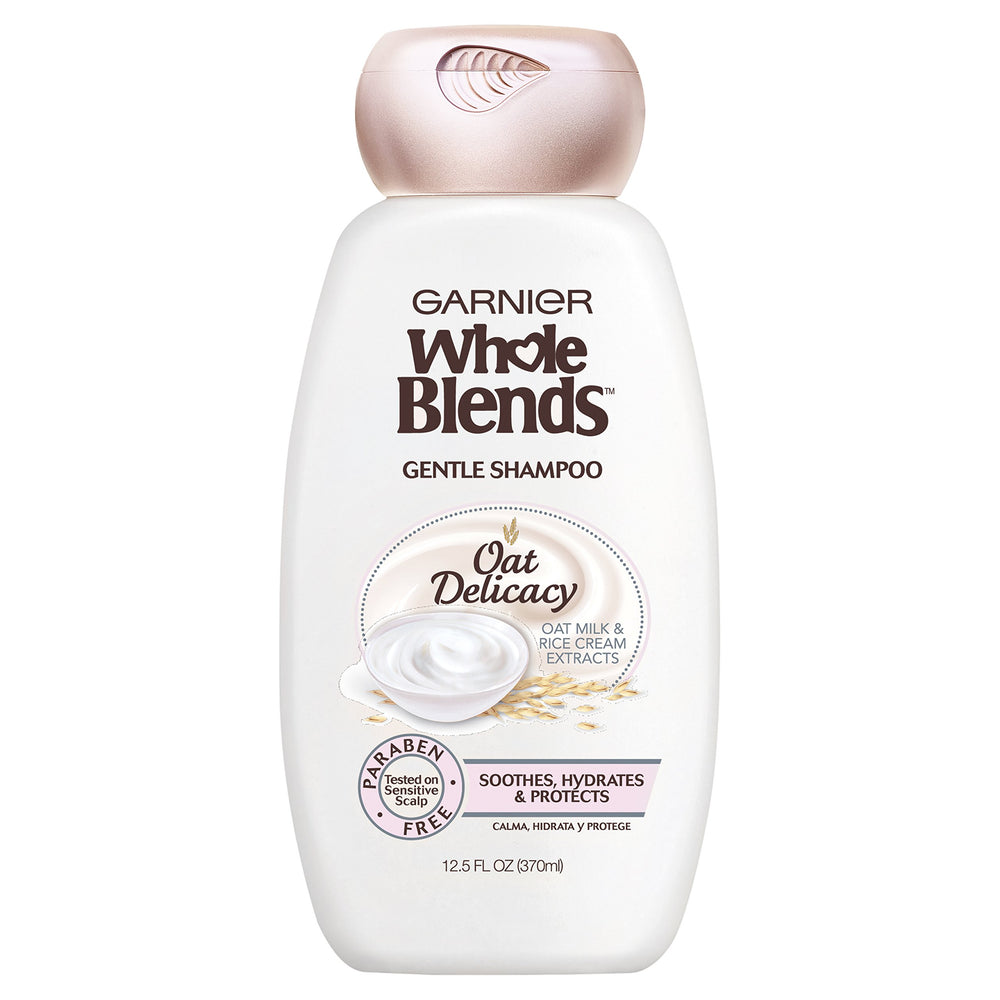 Garnier Whole Blends Gentle Shampoo Oat Delicacy bottle pouring for weightless hydration