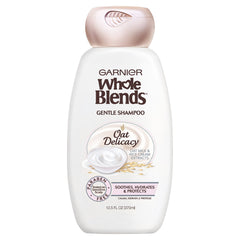 Garnier Whole Blends Gentle Shampoo Oat Delicacy bottle pouring for weightless hydration