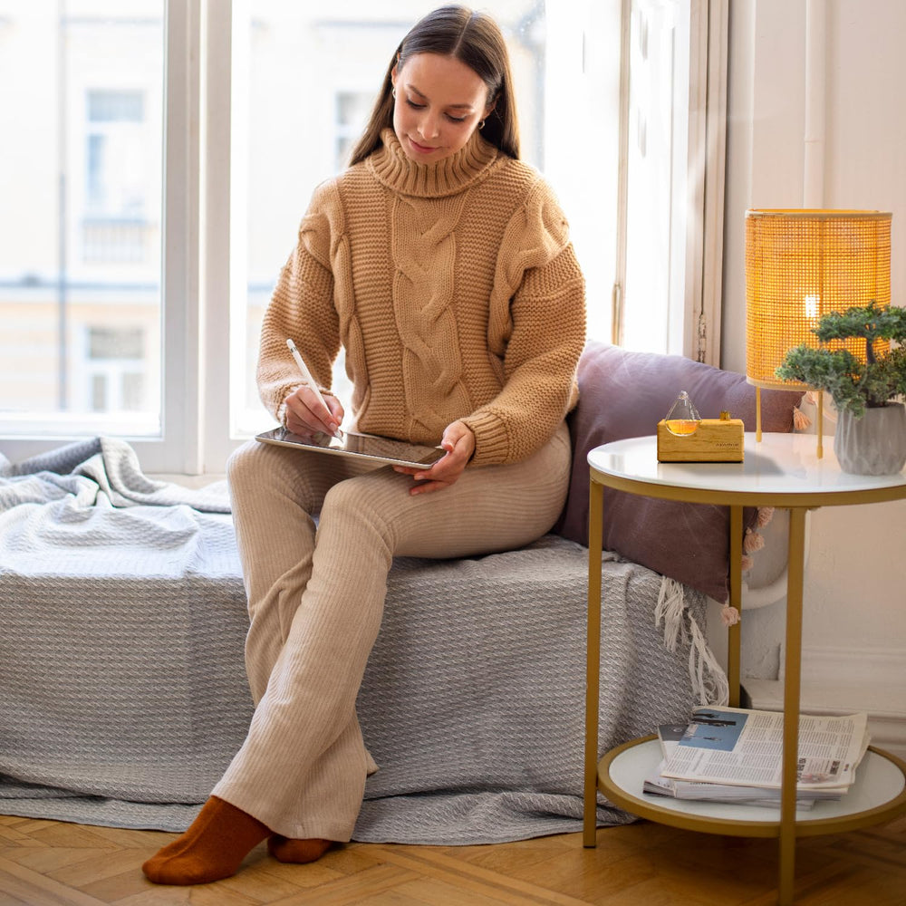 Close-up of glass diffuser and natural wood base detailing