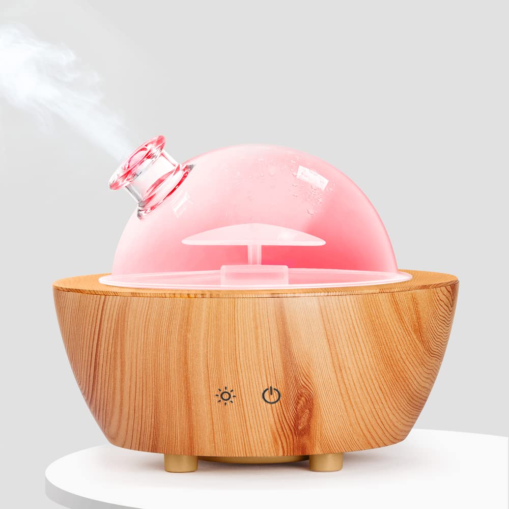 Glass essential oil diffuser with wood grain base on a nightstand