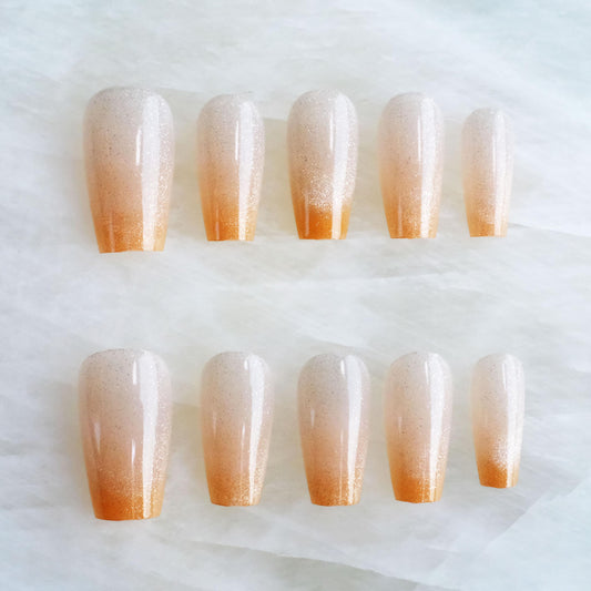GLORS glossy cat eye ballerina nails in orange ombre with glitter for a show-stopping look.