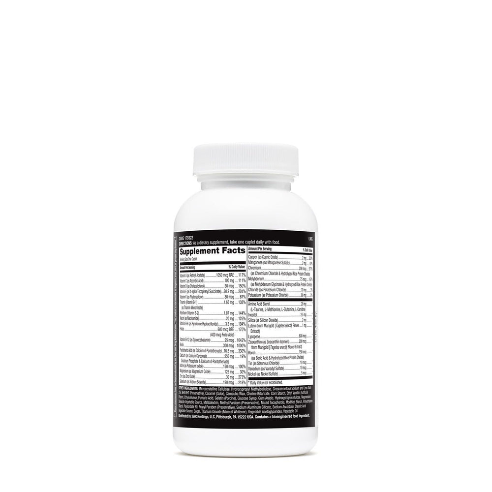 Multivitamin tablets spilled beside the bottle on white background