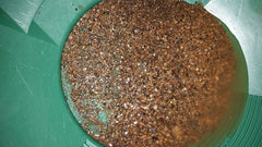 Hands scooping paydirt from a Colorado creek