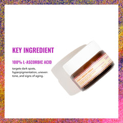 Spoon scooping Vitamin C booster powder into skincare product