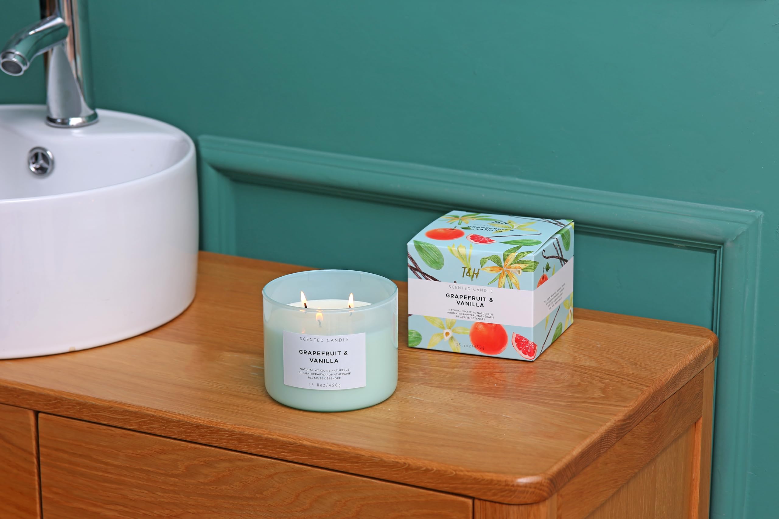 Empty candle jar repurposed as a decorative vase