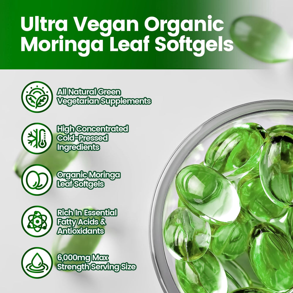 Green moringa capsules on white background