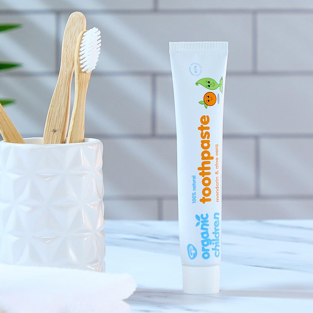 Child brushing teeth with GREEN PEOPLE Kids Mandarin Toothpaste 50 ml