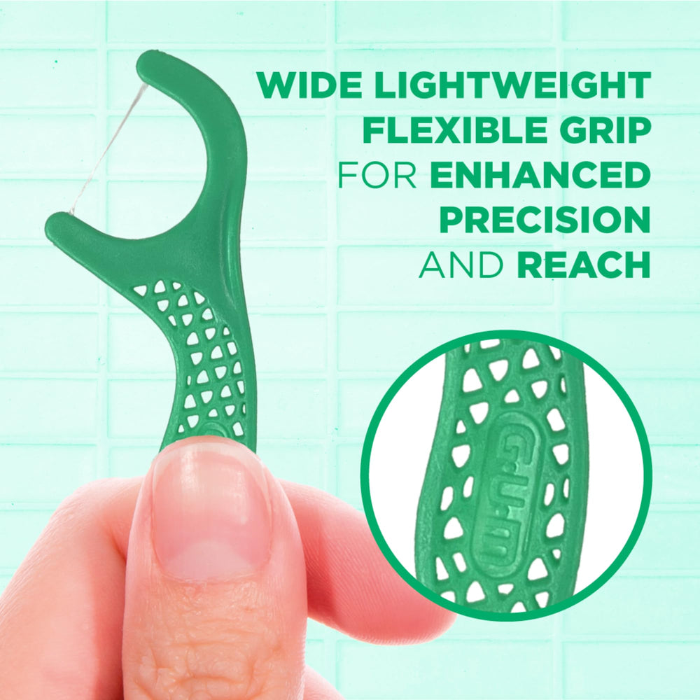 Using floss pick to clean between teeth