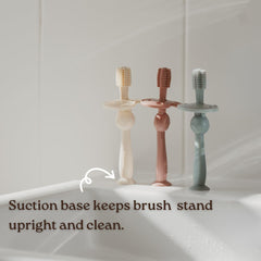 Gums being massaged with Haakaa 360° silicone toothbrush pink
