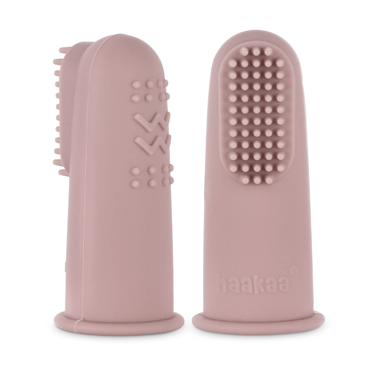 Blush Haakaa finger toothbrush held beside a hand