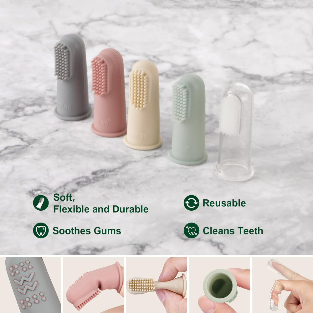 Baby using finger toothbrush on gums