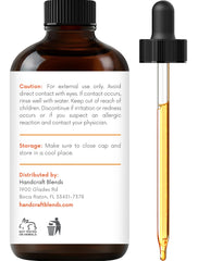 Close-up of dropper dispensing grapefruit essential oil
