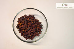 Close-up of dried hawthorn berries with rich red color
