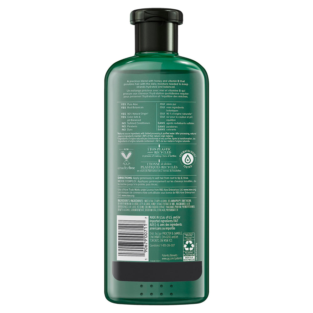 Creamy conditioner texture being applied to hair for smooth finish.