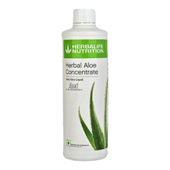 Herbalife Herbal Aloe Concentrate bottle being poured for a refreshing digestion-supporting drink.