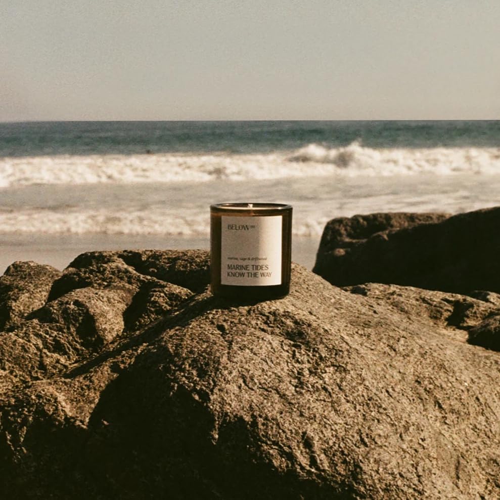 Close-up view of Hilary Duff’s Below 60 candle label on a 7.2oz jar