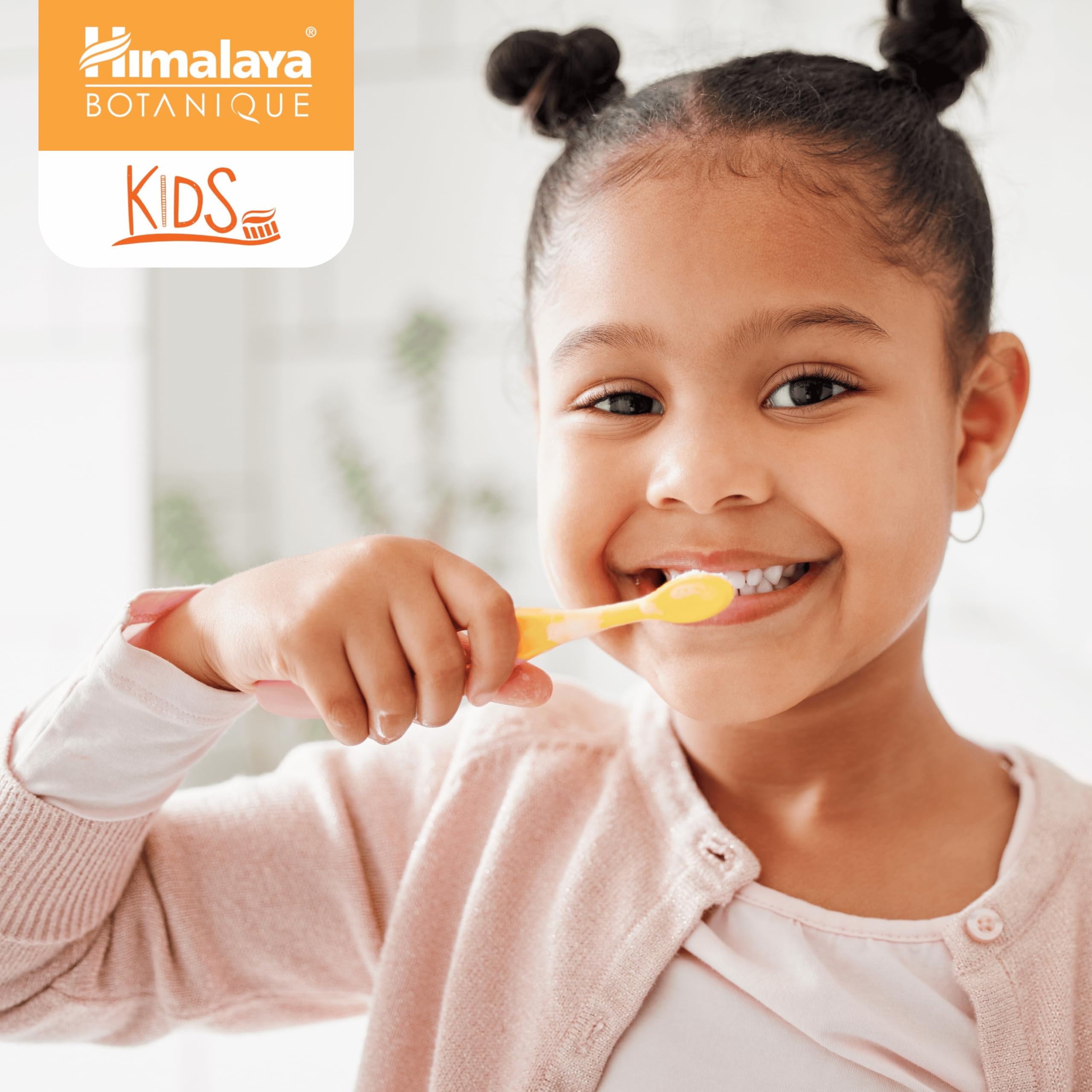 Child brushing teeth with Himalaya Botanique orange toothpaste