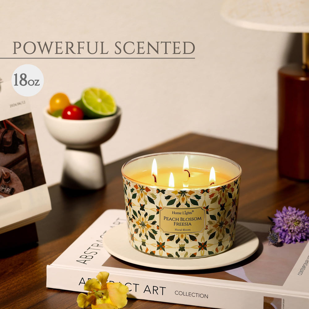 Close-up of HomeLights 18oz 4-wick candle displaying Peach Blossom Freesia scent
