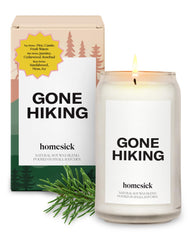 Homesick Gone Hiking 13.75 oz candle in jar with pine forest background