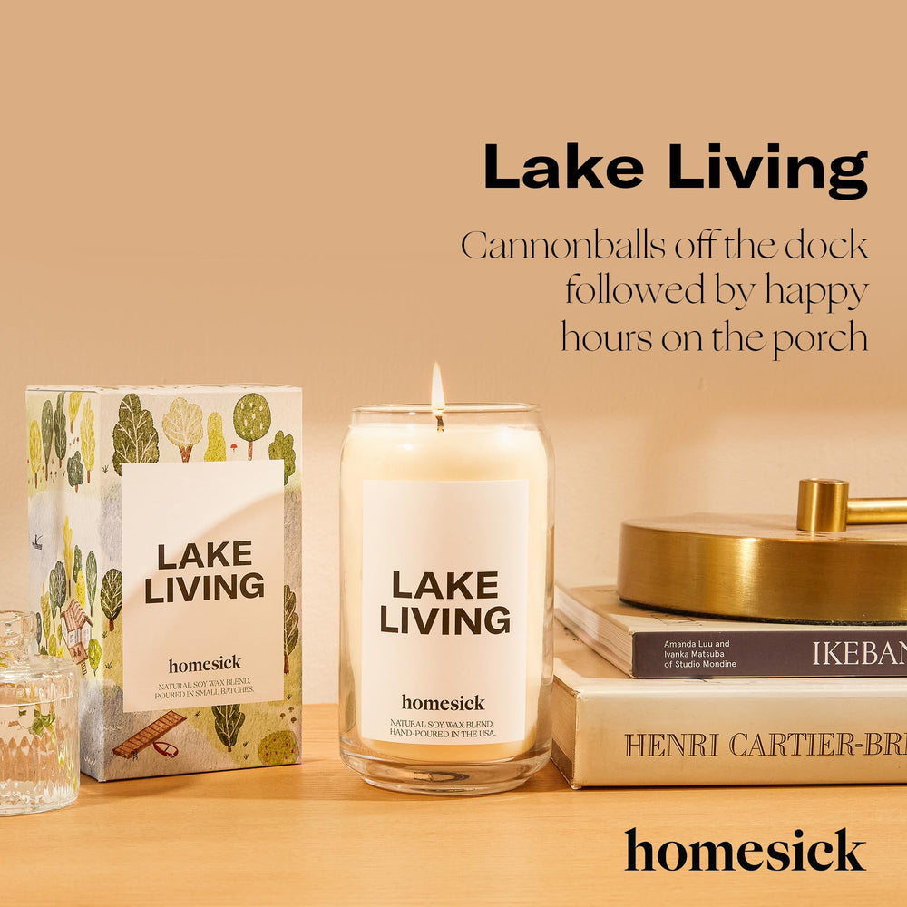 Homesick Lake Living candle lit on a porch with a lake view