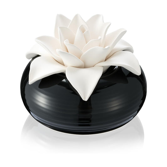 Honeydak white porcelain flower diffuser with ceramic rose top on a table
