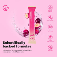 Cranberry-flavored probiotic powder being measured with a scoop