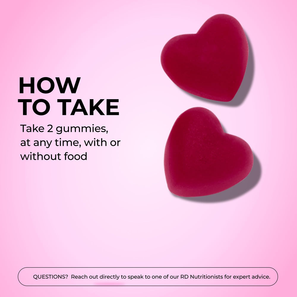 Two HUM Hair Growth Gummies being taken as a daily supplement