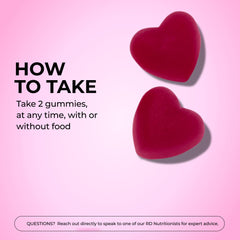 Two HUM Hair Growth Gummies being taken as a daily supplement