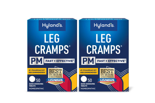 Hyland's Leg Cramps PM bottle on nightstand offering nighttime cramp relief