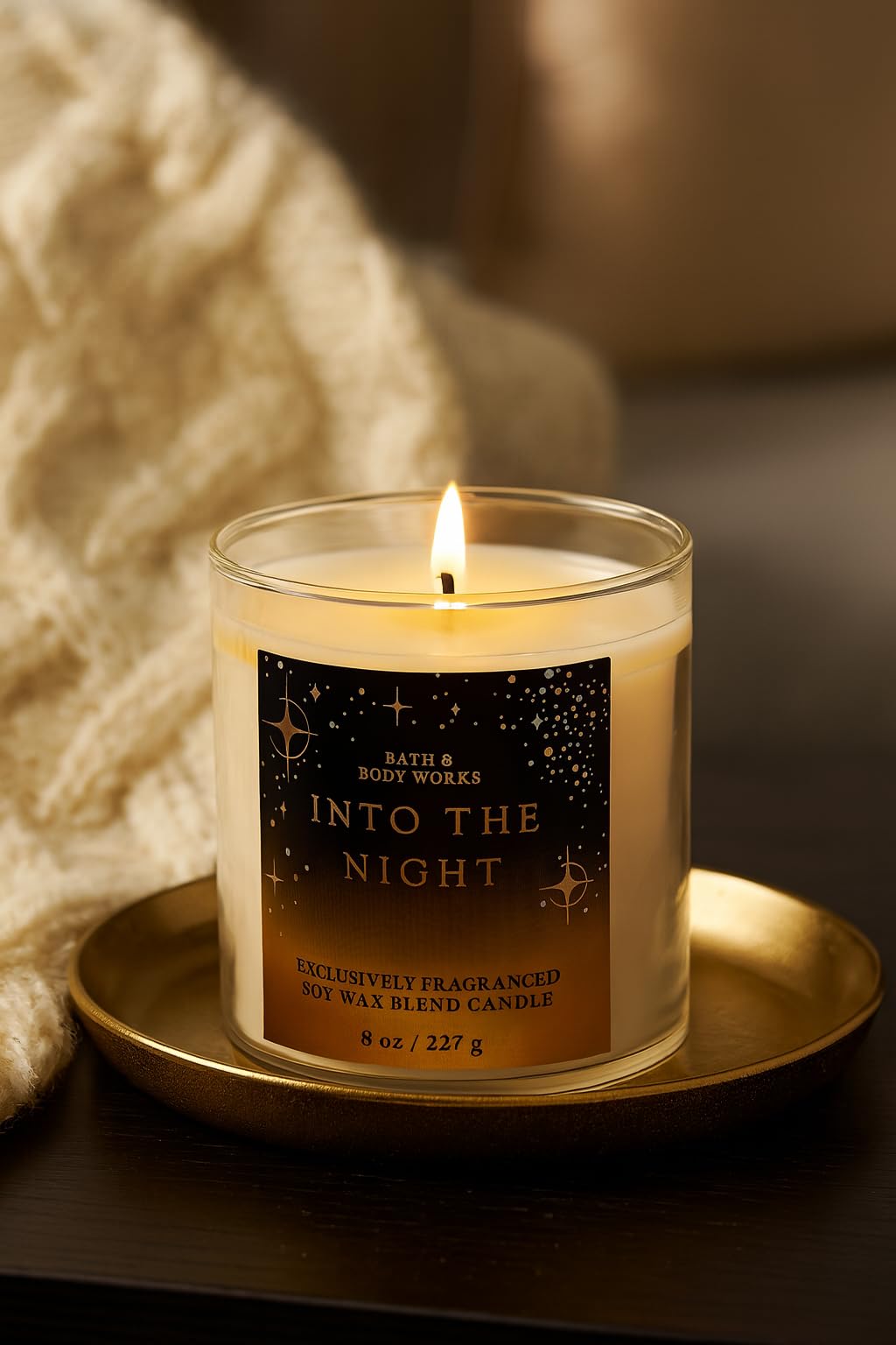 Close-up of Bath & Body Works Into The Night candle label on glass jar
