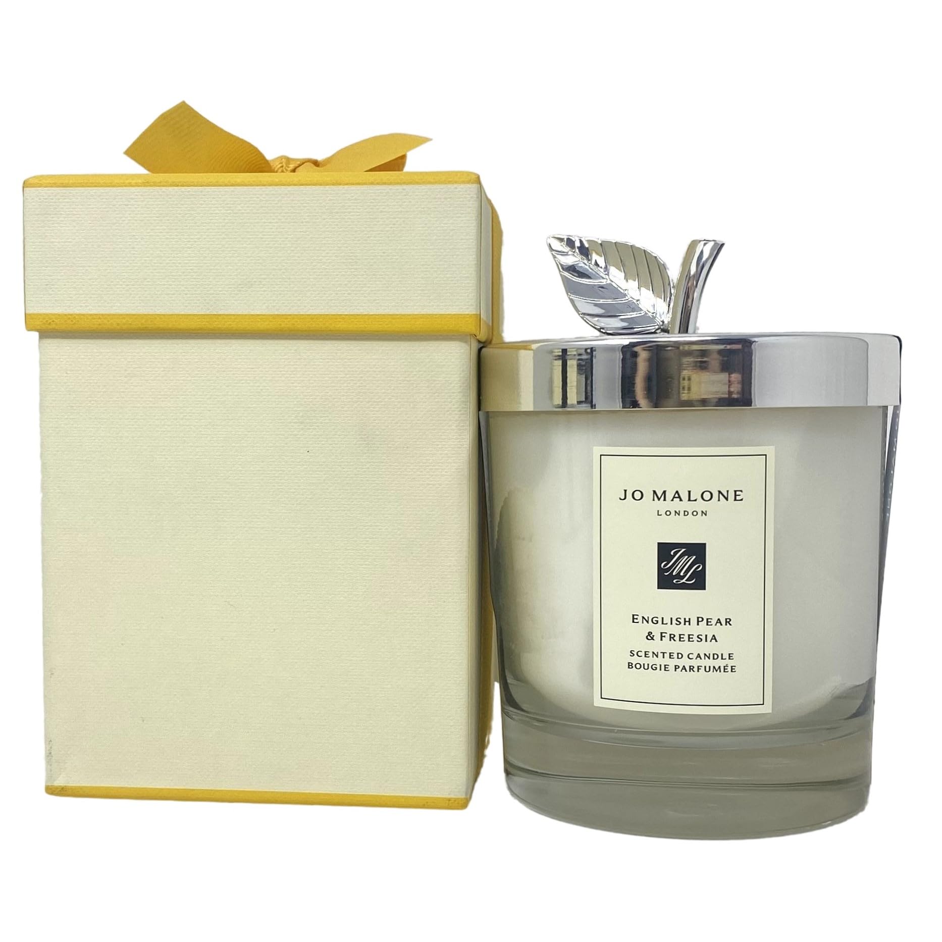 Jo Malone English Pear & Freesia candle with lid evokes warm orchard ambiance.