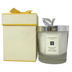 Jo Malone English Pear & Freesia candle with lid evokes warm orchard ambiance.