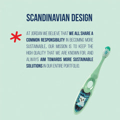 Jordan* toothbrush held in child's hand demonstrating child-friendly size