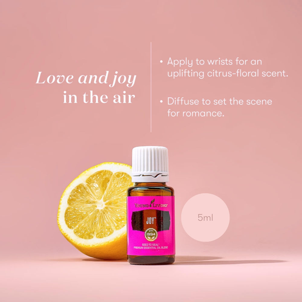 Joy Essential Oils Blend on a white background with citrus fruits