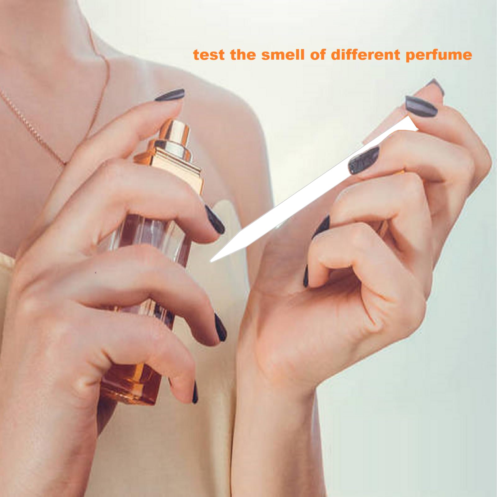 Joysorn perfume test strips being dipped to sample a fragrance.