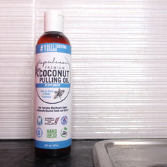 Pure coconut oil pulling oil bottle close-up