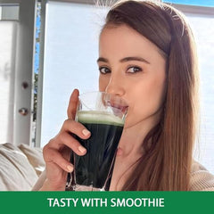 Scoop of spirulina powder being added to a smoothie