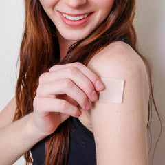 Applying Keto Complete Daily Patch to the skin