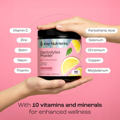 Chilled pink lemonade drink beside ice for refreshing hydration on the go.