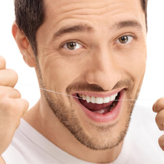 Breath-freshening dental floss keychain in hand