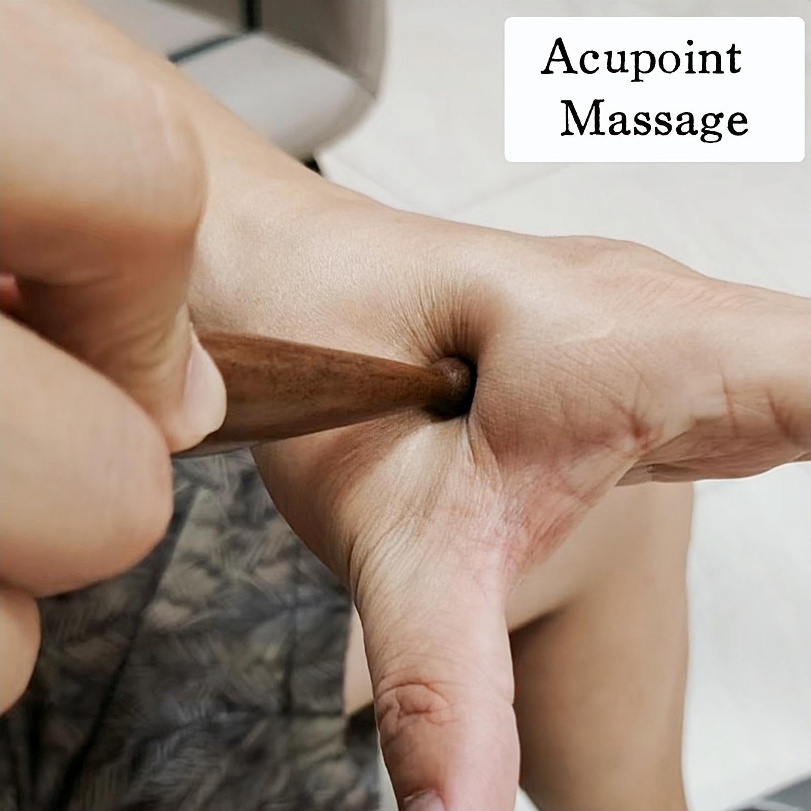 Handheld massage pen resting on palm for compact size