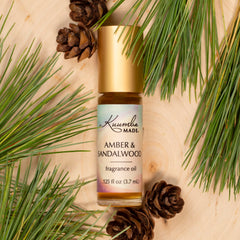 Kuumba Made Amber and Sandalwood roll-on cap close-up highlighting premium design.
