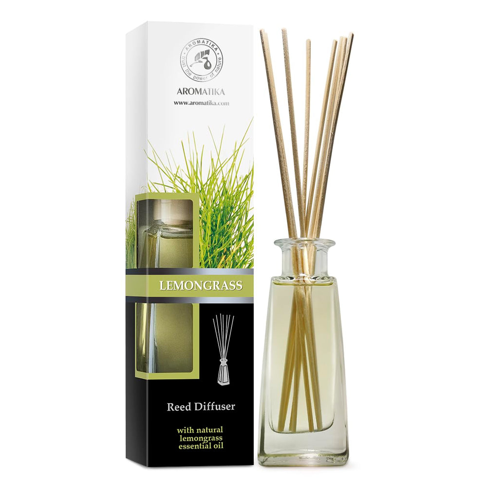 Lemongrass diffuser bottle and reeds on a white surface