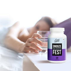 Calm sleeping environment with Snooze Fest bottle and soft lighting