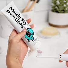 Watermelon-flavored toothpaste tubes and recyclable packaging for Made by Dentists Kids Shark Toothpaste 4.2oz 3-Pack