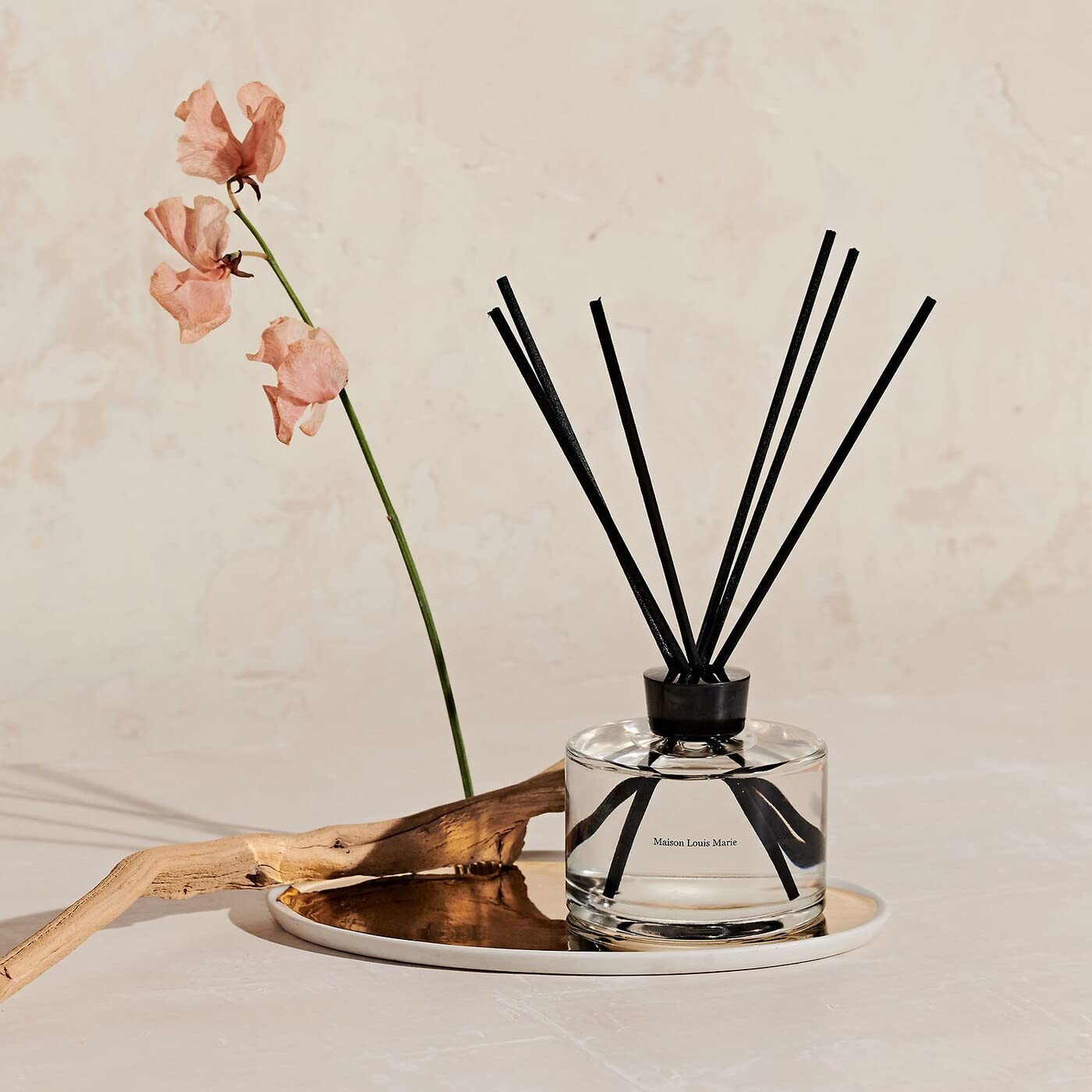 Close-up of diffuser bottle and natural reeds