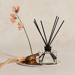Close-up of diffuser bottle and natural reeds