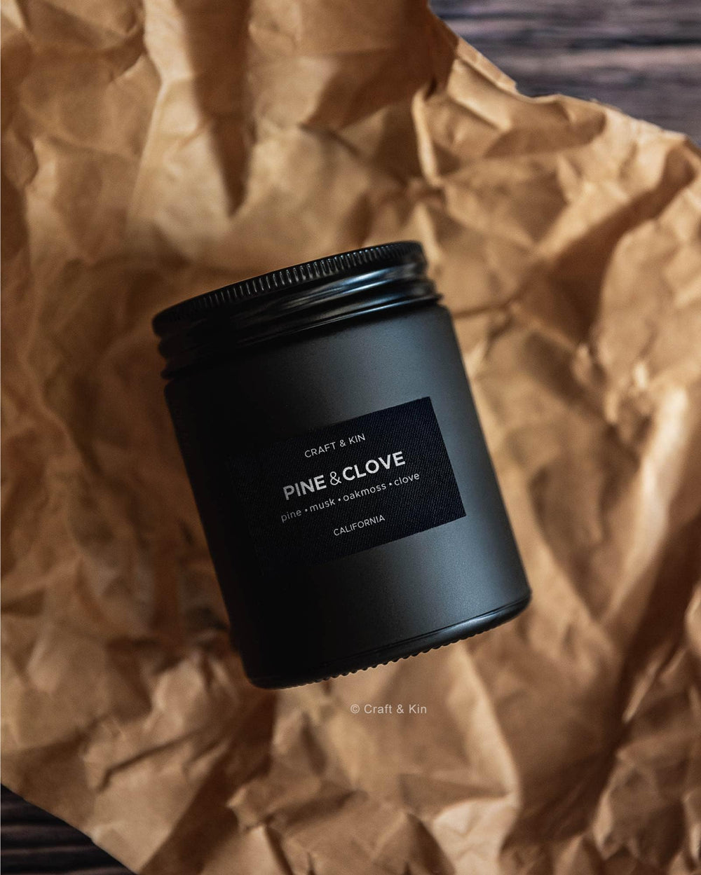 Masculine candle in a home setting with warm glow