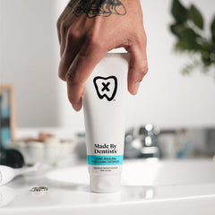 Toothpaste tube showing fluoride and remineralizing ingredients